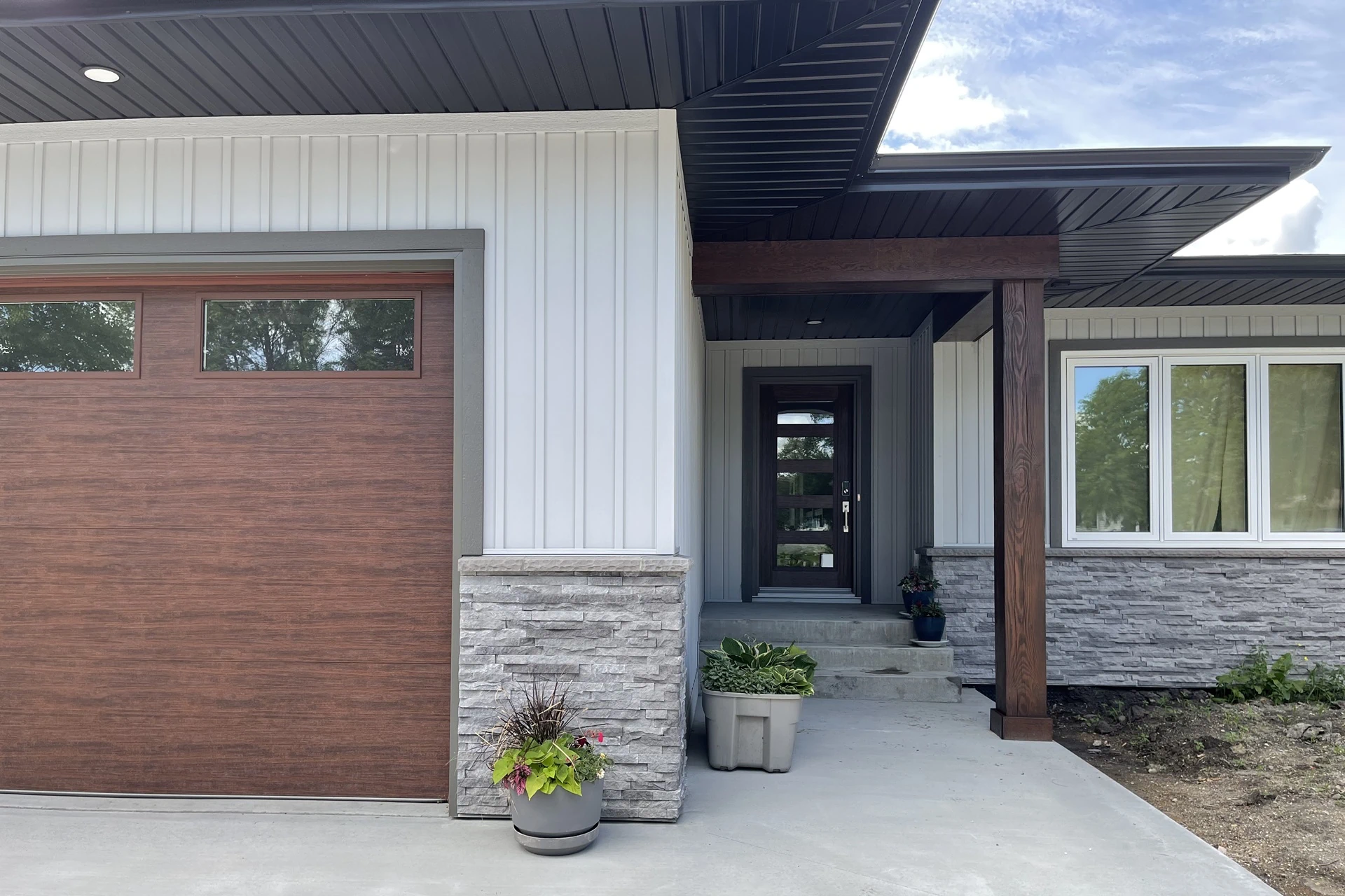 Modern exterior of home with wood and stone accents