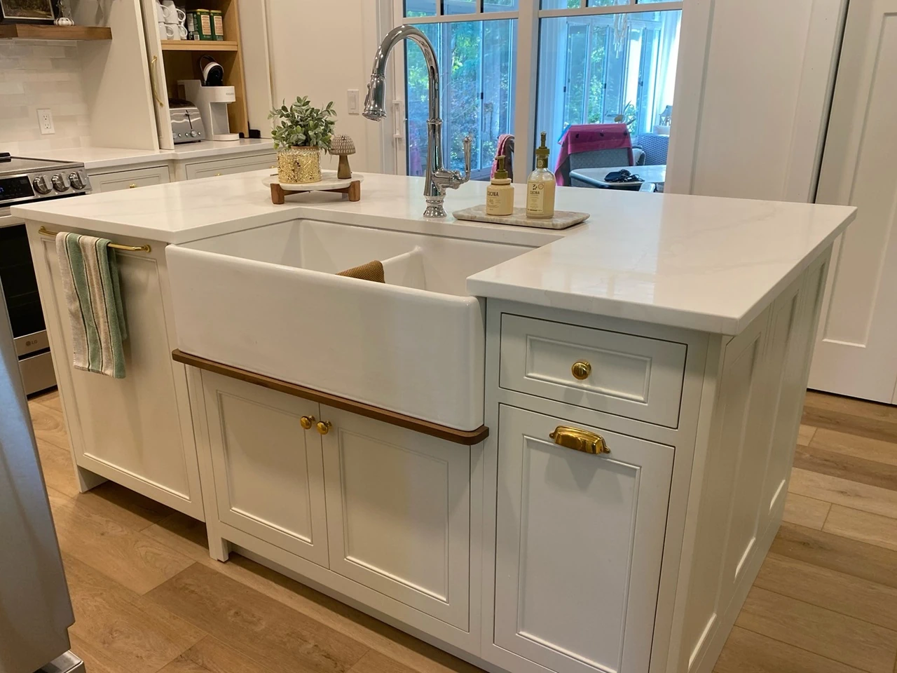 kitchen island with sink and white cabinets