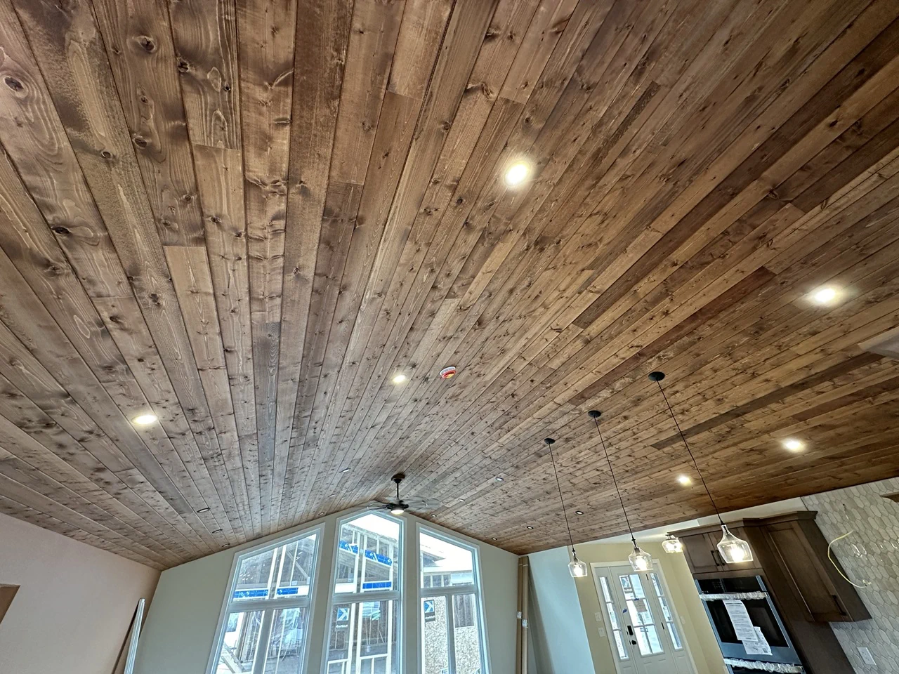 stained wood boards installed on a ceiling