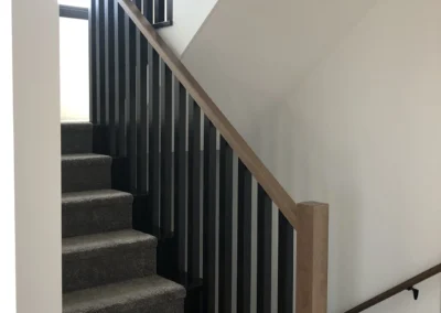 staircase with stained wood railing