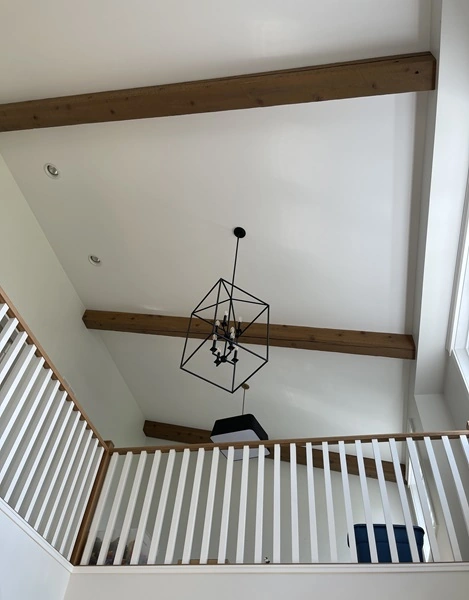 wooden beams on white ceiling